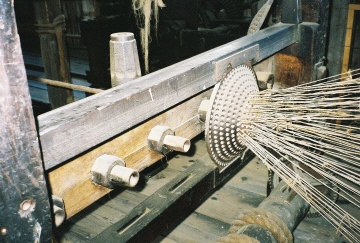 Individual yarn
                    threaded into machine to form strand